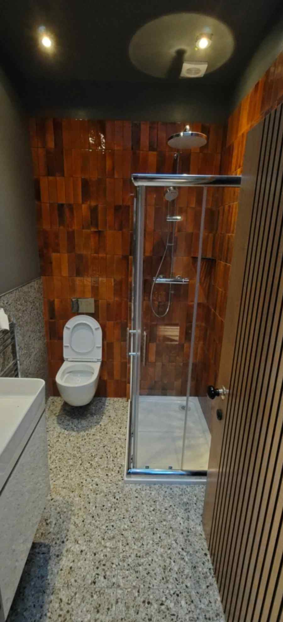 En-suite — terracotta tiles & rain shower